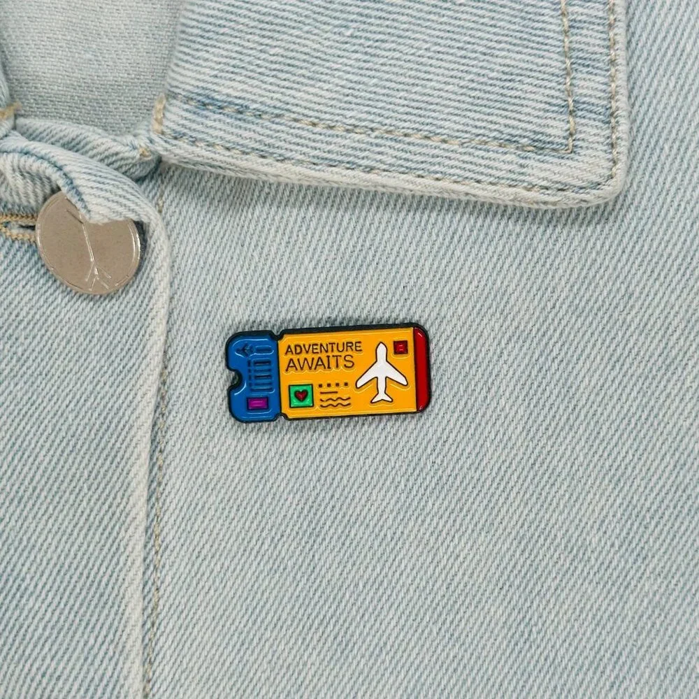 ⭐Enamel Pin Adventure Awaits Ticket Airplane Brooch Icon Cartoon Yellow New - Picture 1 of 5